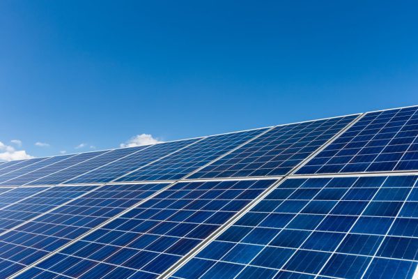 solar-panels-against-a-blue-sky-e1696032253767.jpg